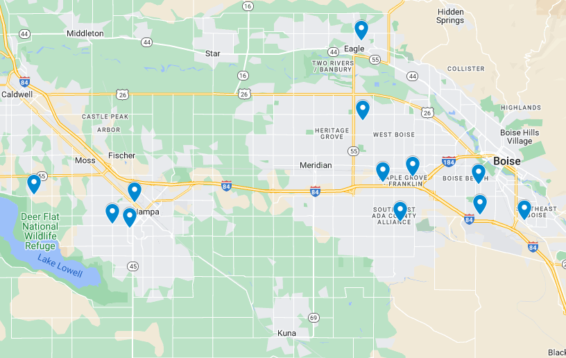 A map depiction of Boise, Idaho, and its surrounding areas showing various blue map markers indicating specific locations. Major highways and streets are visible, along with the names of regions and landmarks such as the Deer Flat National Wildlife Refuge and Lucky Peak. Additionally highlighted are spots offering commercial painting services.